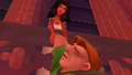 Esmeralda saves Quasimodo from falling off the cathedral.